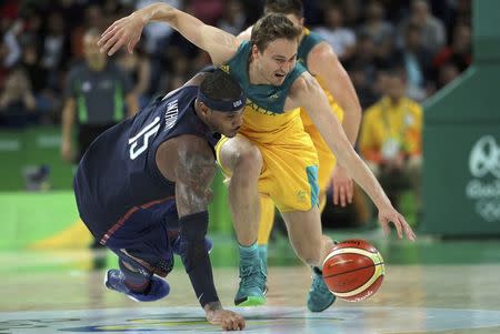 Carmelo Anthony (USA) of the USA and Ryan Broekhoff (AUS) of Australia chase a loose ball. REUTERS/Jim Young