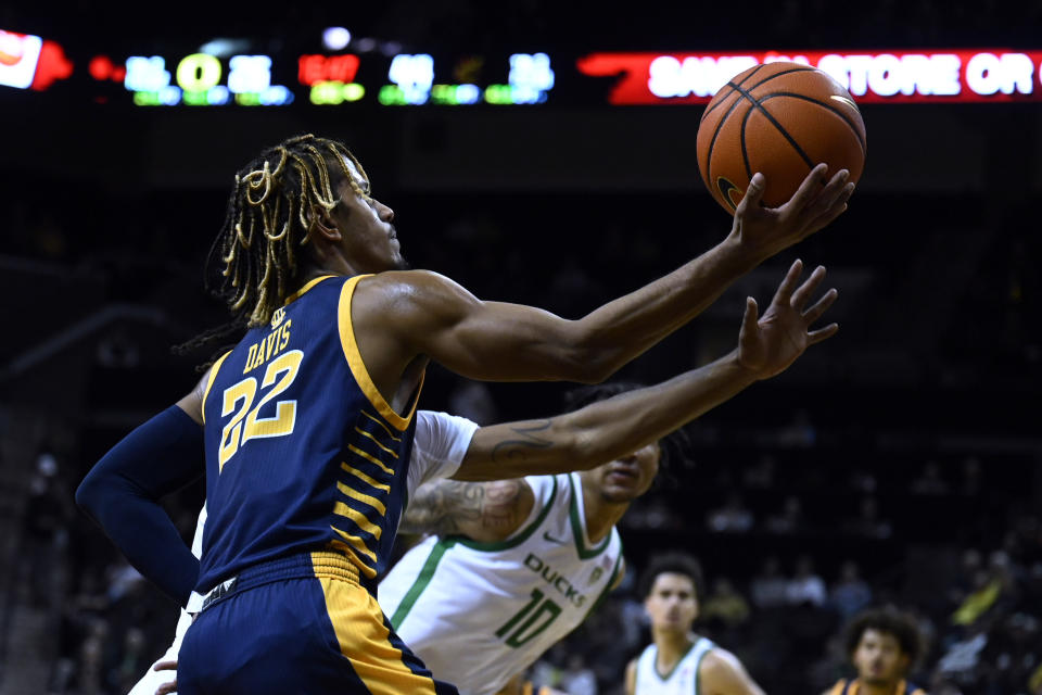 UC Irvine guard DJ Davis (22) drives past Oregon center Kel'el Ware (10) for a score during the second half of an NCAA college basketball game Friday, Nov. 11, 2022, in Eugene, Ore. (AP Photo/Andy Nelson)