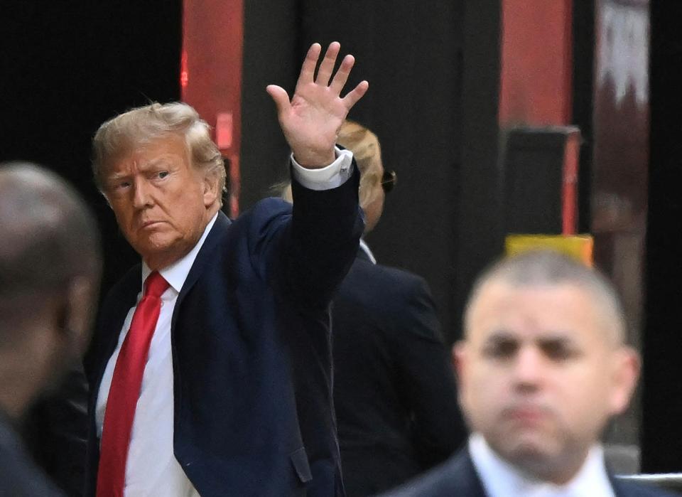 Former US President Donald Trump waves as he arrives at Trump Tower in New York on April 3, 2023. - Trump arrived in New York where he will surrender to unprecedented criminal charges, taking America into uncharted and potentially volatile territory as he seeks to regain the presidency. The 76-year-old Republican, the first US president ever to be criminally indicted, will be formally charged on April 4, 2023 over hush money paid to a porn star during the 2016 election campaign. (Photo by Ed JONES / AFP) / ALTERNATE CROP (Photo by ED JONES/AFP via Getty Images)