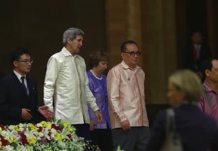 U.S. Secretary of State John Kerry (2nd L) and North Korean Foreign Minister Ri Su Yong walk as they attend a photo session before a gala dinner at Myanmar International Convention Centre (MICC) in Naypyitaw August 9, 2014. REUTERS/ Soe Zeya Tun