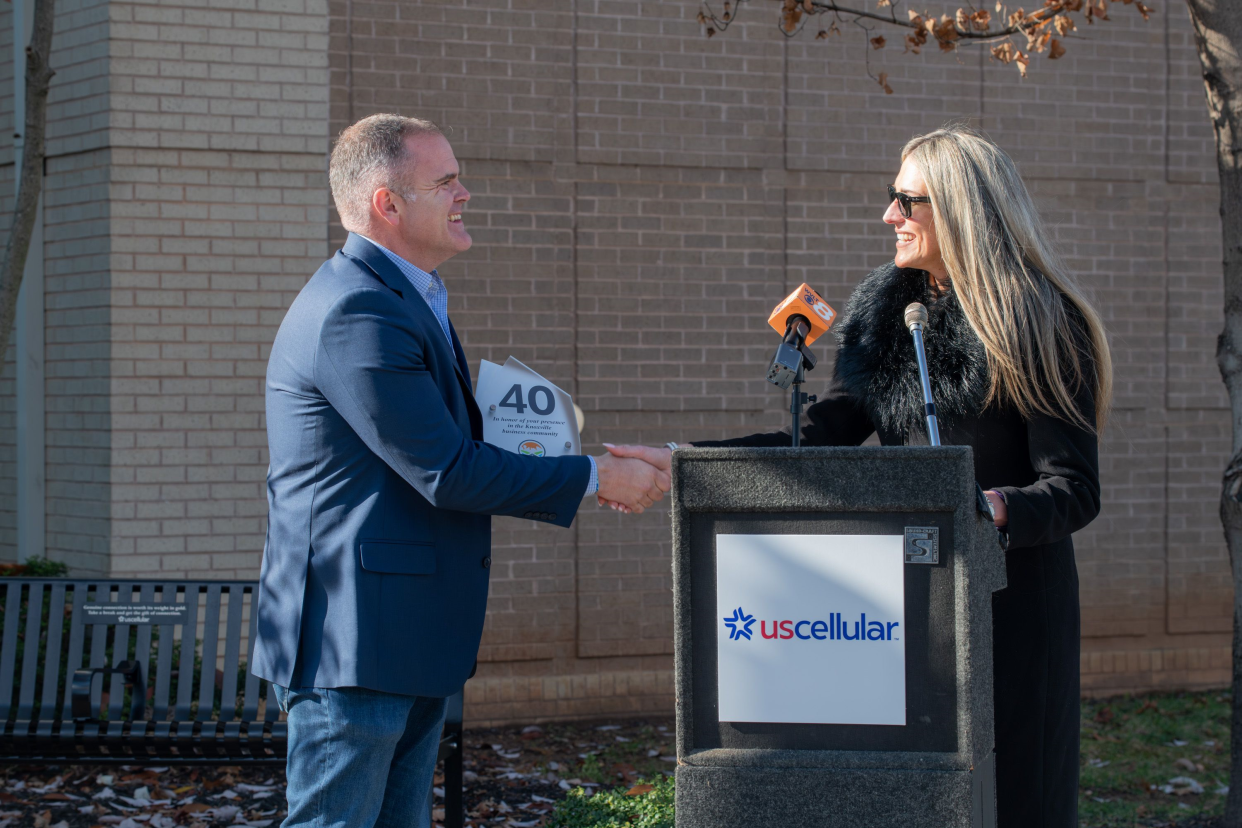 UScellular’s Thomas White accepts a plaque commemorating 40 years in the Knoxville business community from Ashleigh Christian of the Knoxville Chamber. Dec. 5, 2023