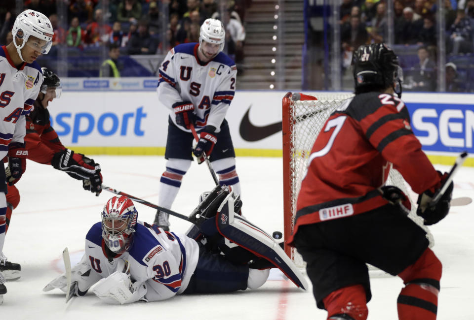 Canada's Barett Hayton, right, scores sides fourth goal past goaltender Spencer Knight of the US during the U20 Ice Hockey Worlds match between Canada and the United States in Ostrava, Czech Republic, Thursday, Dec. 26, 2019. (AP Photo/Petr David Josek)