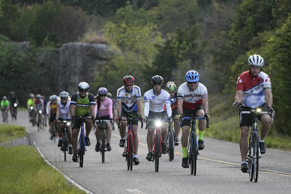 Cyclists ride during a memorial to remember Alyssa Milligan, Tuesday, Sept. 12, 2023, in Mount Juliet, Tenn. Milligan was struck and killed by a pickup truck while cycling with a friend the previous week. (AP Photo/George Walker IV)