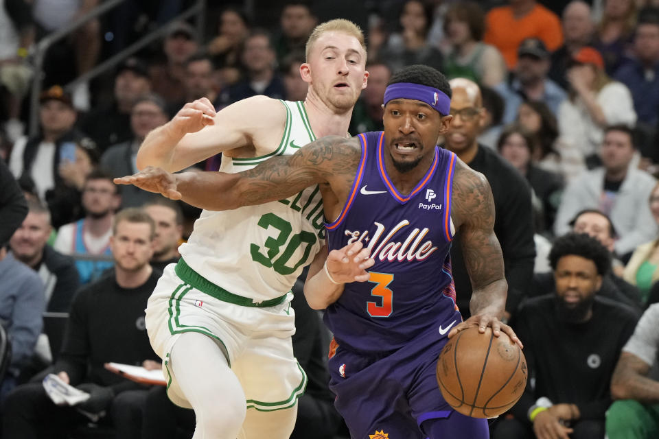 Phoenix Suns guard Bradley Beal (3) drives past Boston Celtics forward Sam Hauser (30) during the second half of an NBA basketball game, Saturday, March 9, 2024, in Phoenix. (AP Photo/Rick Scuteri)