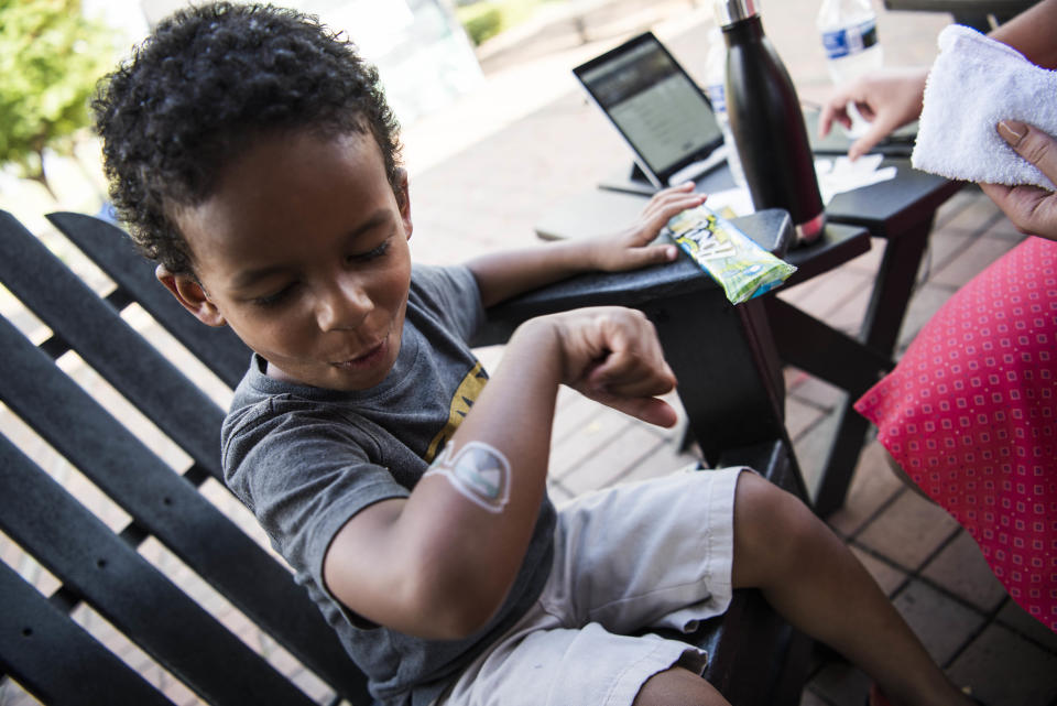 Jonathan, who is 4 years old, checks out his temporary tattoo.