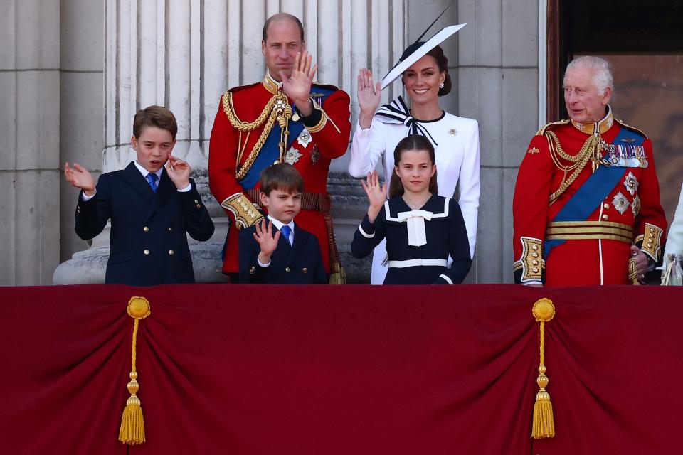 Prince William and Princess Kate, seen on the balcony of Buckingham Palace with their children and the King.