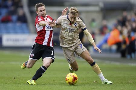 Millwall's Lee Martin (R) challenges Brentford's Alan Judge during their English Championship League soccer match at The Den in London November 8, 2014. REUTERS/Paul Hackett