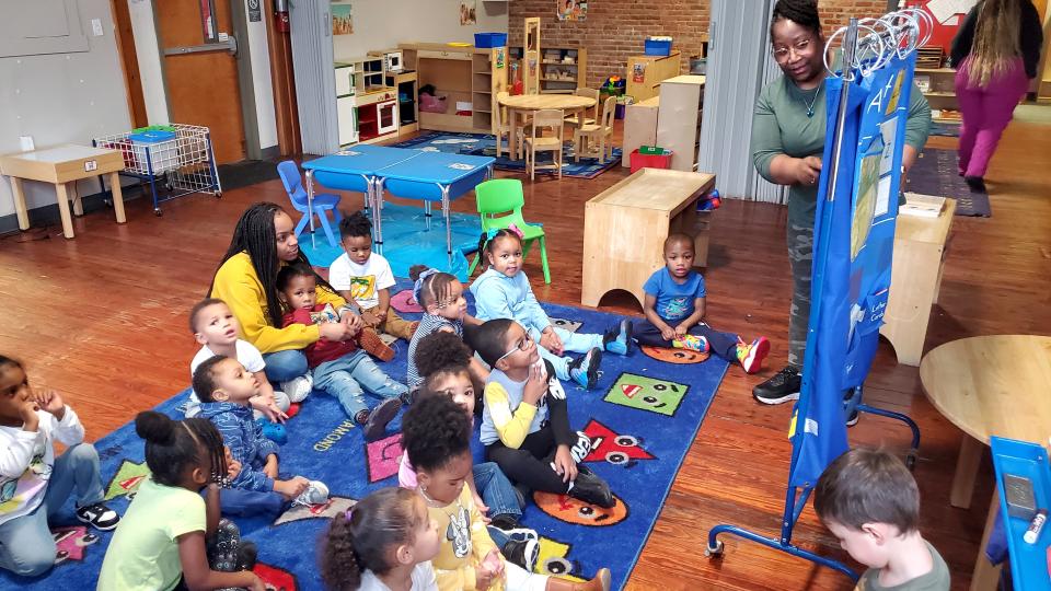 Dana Woodson reviews the days of the week with a class of 16, 3- and 4-year-old students at the Learning Ladder Early Child Care Center, 2502 Peach St., on Jan. 4, 2023. Woodson is the lead teacher for the center's pre-kindergarten program. 