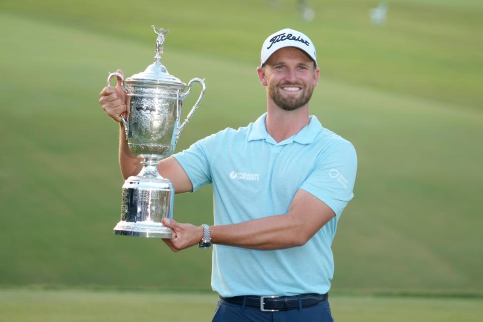 Wyndham Clark poses with the championship trophy after winning the 2023 U.S. Open golf tournament at Los Angeles Country Club.