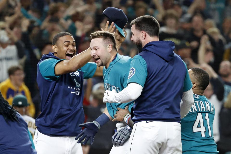 SEATTLE, WASHINGTON - SEPTEMBER 30: Cal Raleigh #29 of the Seattle Mariners celebrates his walk-off home run during the ninth inning against the Oakland Athletics at T-Mobile Park on September 30, 2022 in Seattle, Washington. With the win, the Seattle Mariners have clinched a postseason appearance for the first time  in 21 years, the longest playoff drought in North American professional sports. (Photo by Steph Chambers/Getty Images)