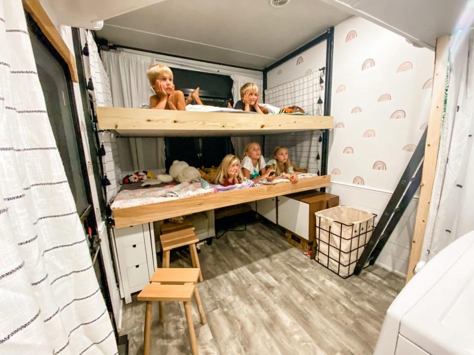 The children laying on their bunk beds in the Proha RV.