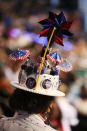 A woman wears a hat decorated with a pinwheel and campaign buttons during day two of the Democratic National Convention at Time Warner Cable Arena on September 5, 2012 in Charlotte, North Carolina. (Photo by Streeter Lecka/Getty Images)