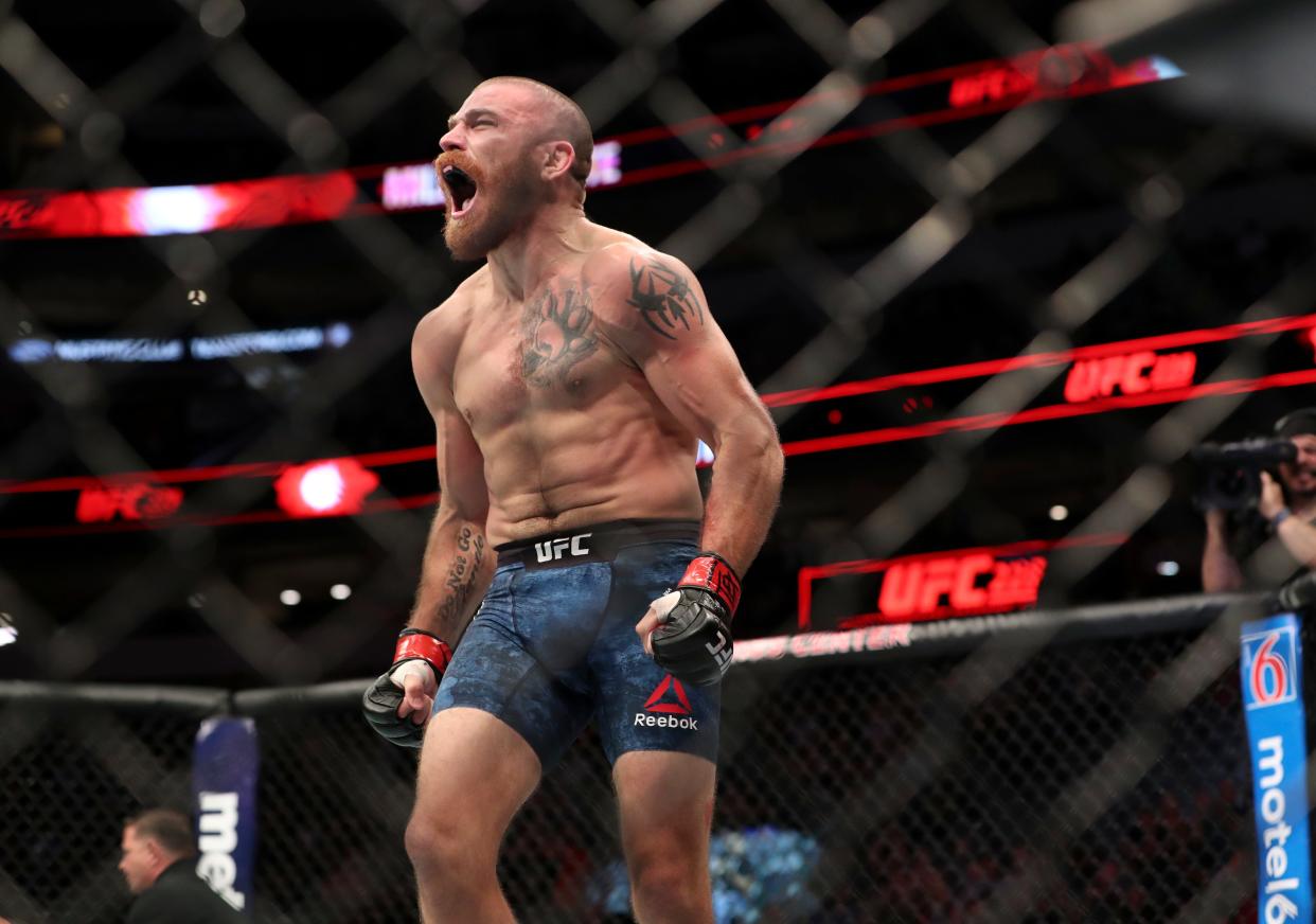 Jim Miller (red gloves) reacts after defeating Alex White (not pictured) during UFC 228 at American Airlines Center.