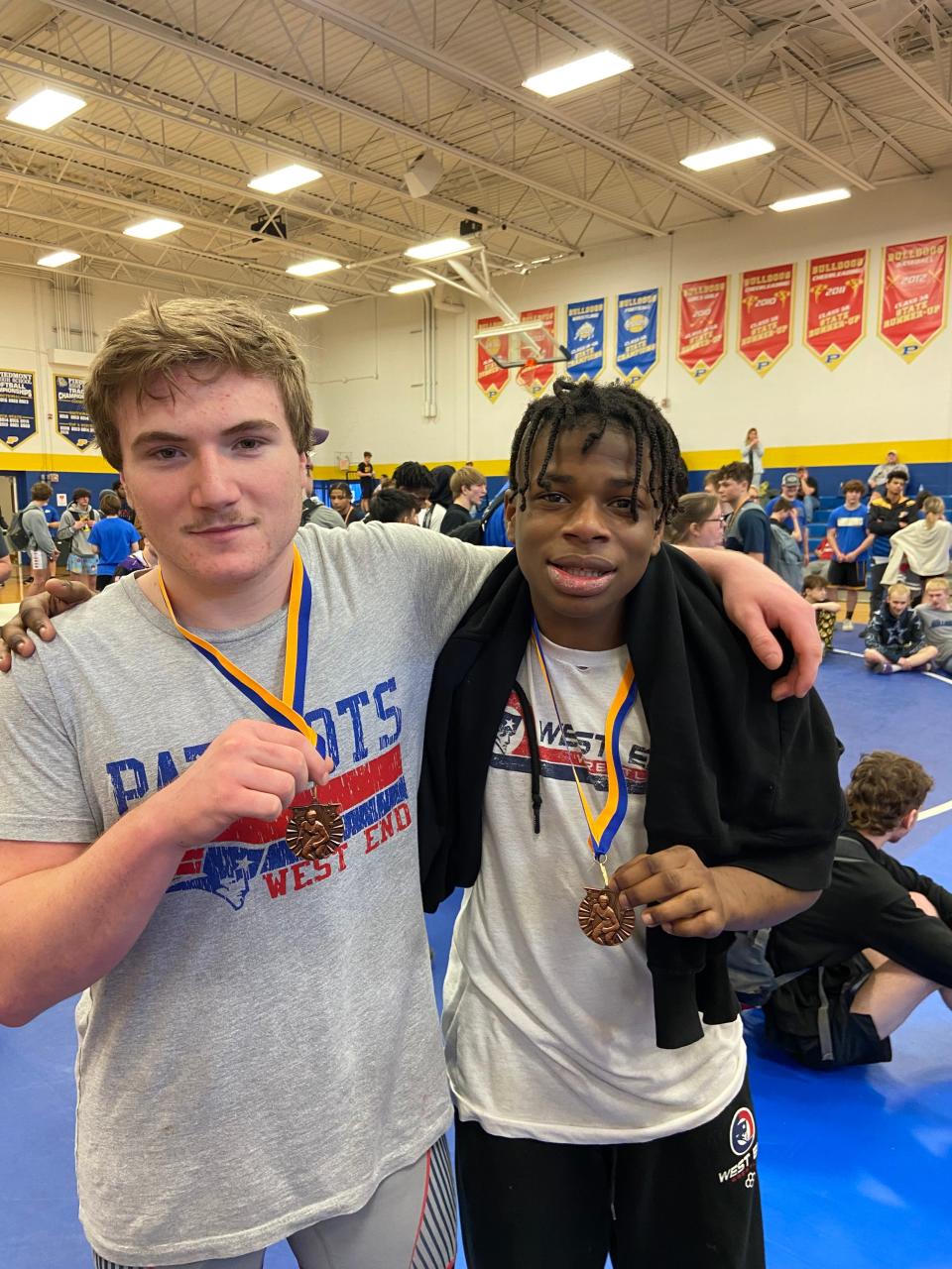 West End wrestlers Hunter Abercrombie and Braison Howard pose with their medals after an event.