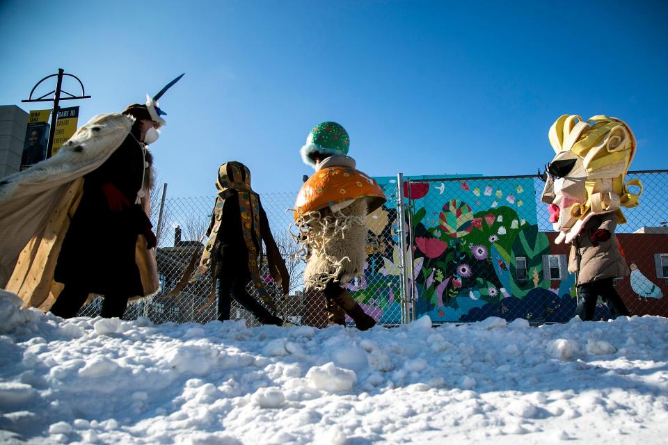 Sayuri Hemann, center, walks along Linn Street in costume during the Iowa City Joy March, Saturday, Jan. 15, 2022, in Iowa City, Iowa.