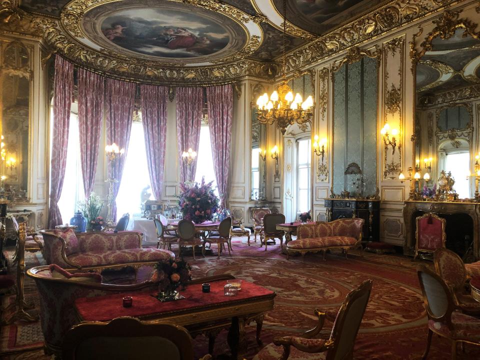 A regal looking room with period furniture and fabrics.