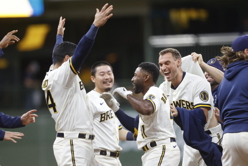 Milwaukee Brewers center fielder Jackie Bradley Jr. (41) celebrates his game winning single against the San Diego Padres in the tenth inning of a baseball game Thursday, May 27, 2021, in Milwaukee. (AP Photo/Jeffrey Phelps)