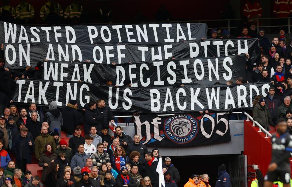 Palace fans raised banners late in the defeat to Arsenal (REUTERS)