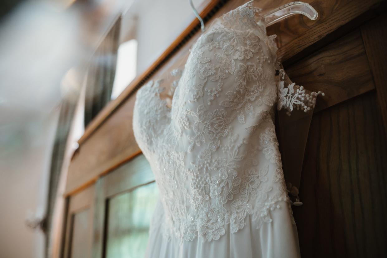 a wedding dress hanged on a closet