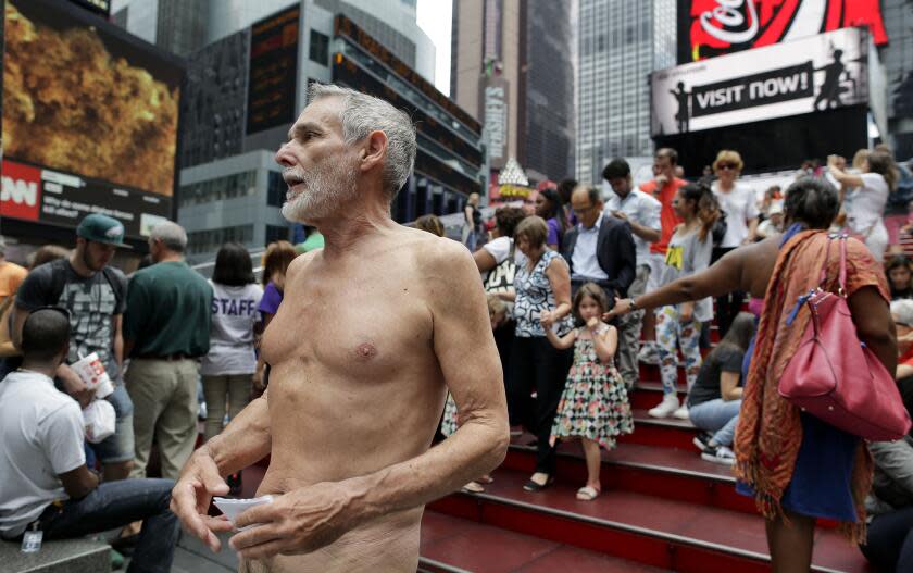 George Davis, a candidate for the San Francisco Board of Supervisors, makes a speech in the nude on Times Square, Wednesday, Aug. 6, 2014, in New York. Davis spoke out against a 2013 San Francisco public nudity ban that was introduced by his opponent, Scott Wiener, saying nudity is a freedom of expression. (AP Photo/Julie Jacobson)