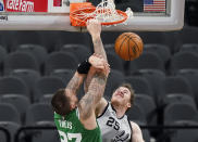 Boston Celtics center Daniel Theis (27) scores over San Antonio Spurs center Jakob Poeltl (25) during the second half of an NBA basketball game in San Antonio, Wednesday, Jan. 27, 2021. (AP Photo/Eric Gay)