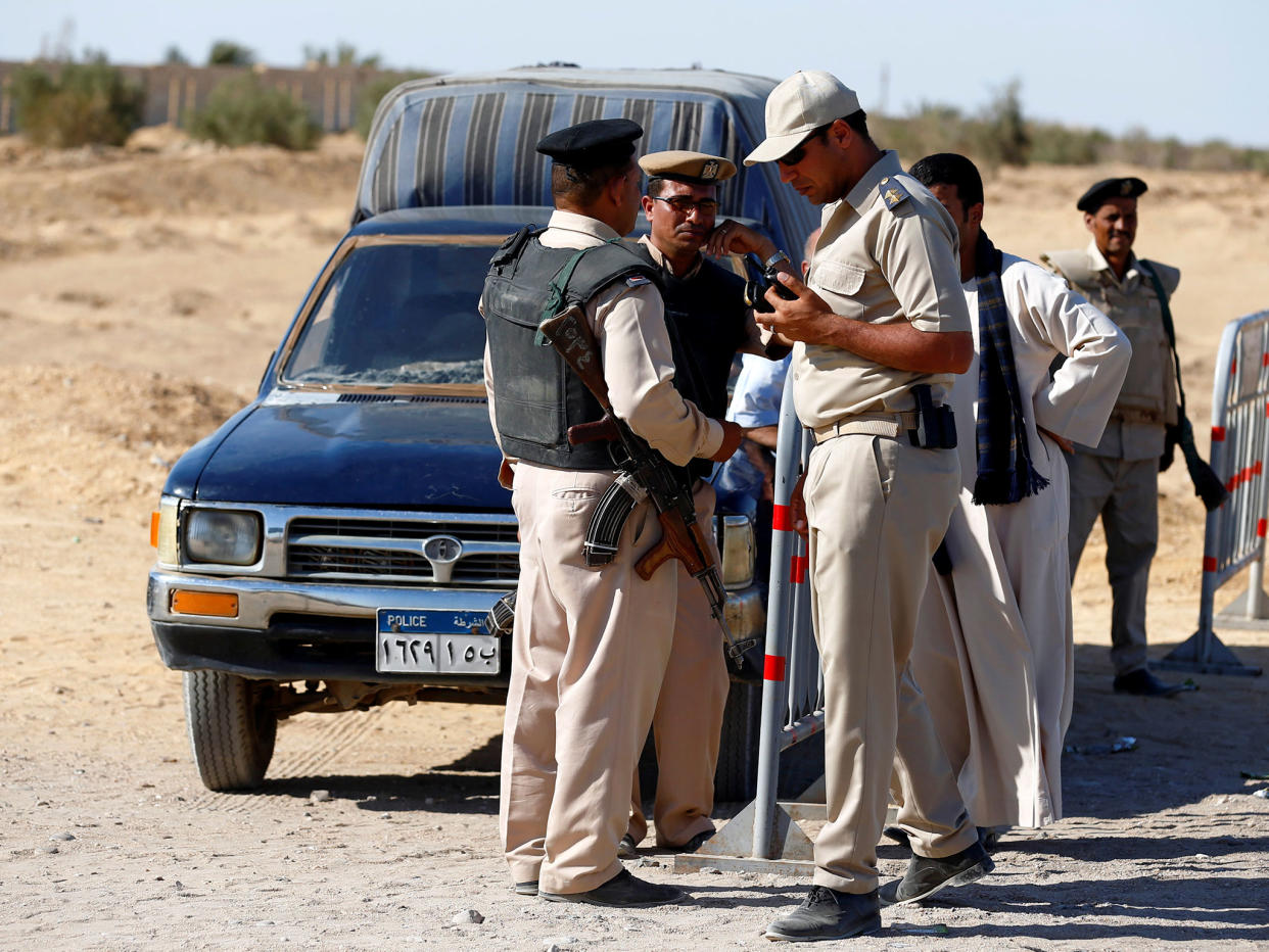 Security guards stand near the site of an attack in Minya, Egypt, on 26 May: Reuters