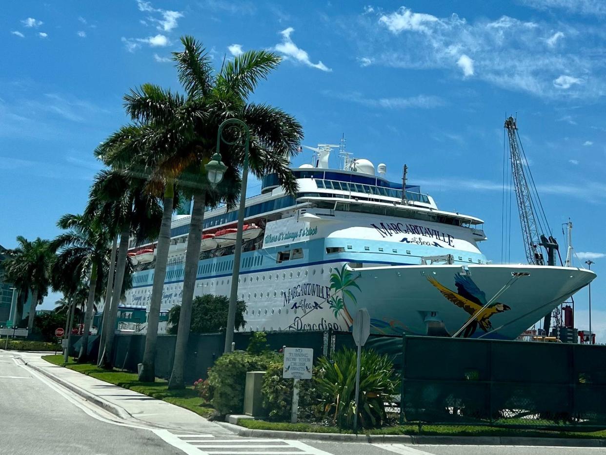 exterior of Margaritaville at Sea with palm trees in front of it