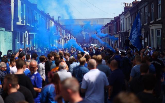General view of Everton fans with flares outside the stadium before the match - Reuters