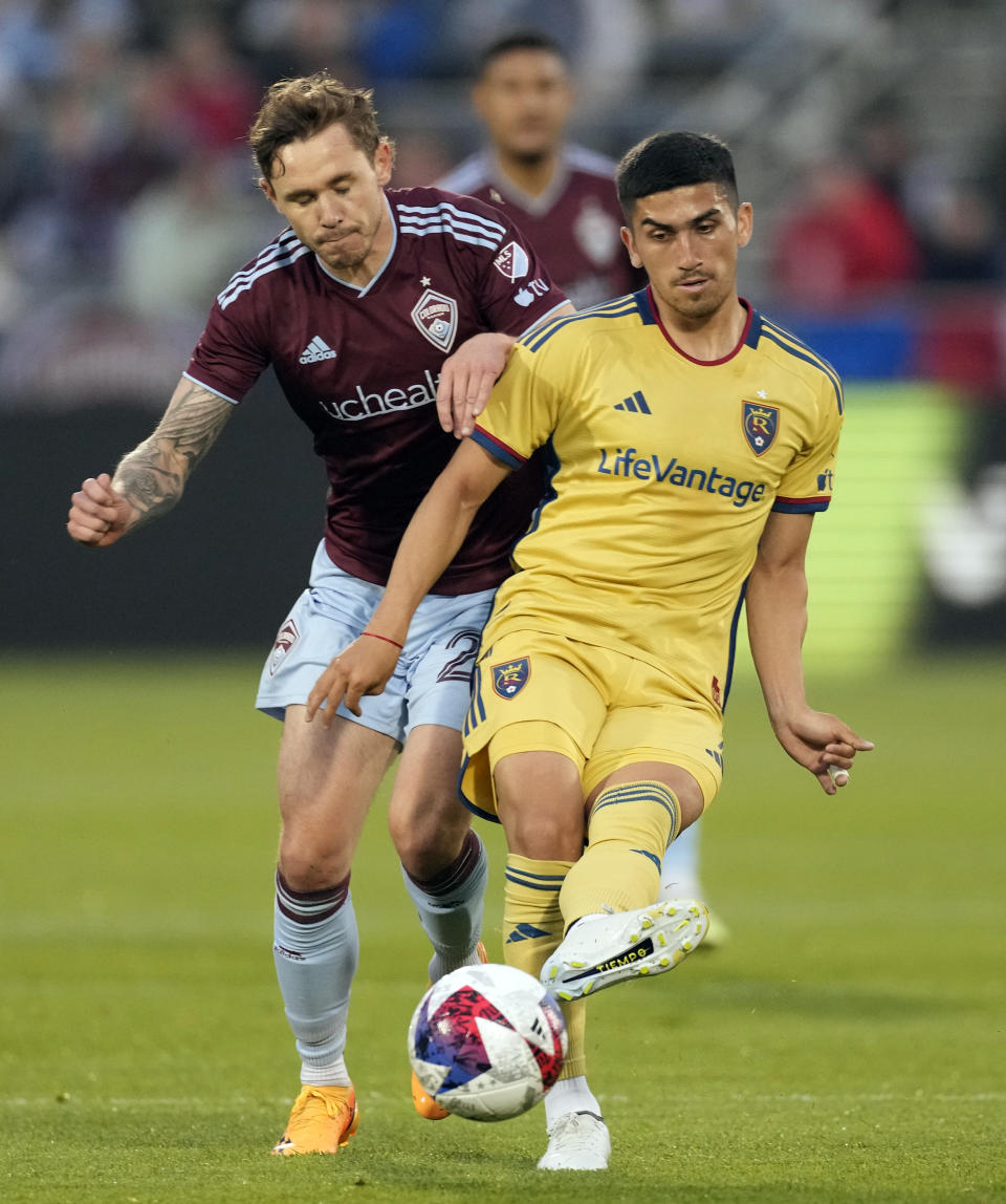 Real Salt Lake midfielder Pablo Ruiz, right, kicks the ball as Colorado Rapids midfielder Sam Nicholson defends in the first half of an MLS soccer match, Saturday, May 20, 2023, in Commerce City, Colo. (AP Photo/David Zalubowski)