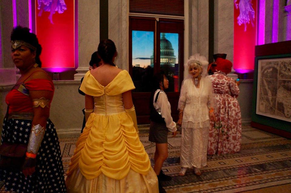 Attendees at the Library of Congress' Literary Costume Ball mingle on the Mezzanine.