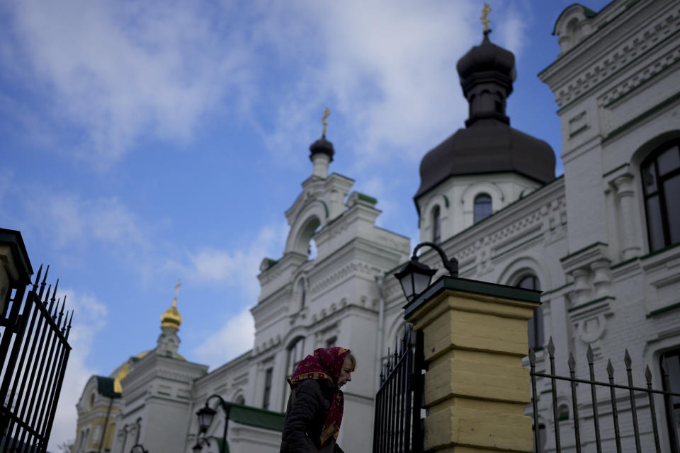 FILE - A woman leaves the Kyiv Pechersk Lavra Monastery in Kyiv, Ukraine, Saturday, May 28, 2022. Ukraine’s counter-intelligence service, police and the country's National Guard on Tuesday, Nov. 22, 2022 searched the Pechersk Lavra monastic complex, one of the most famous Orthodox Christian sites in the capital, Kyiv, after a priest spoke favorably about Russia – Ukraine’s invader – during a service there. (AP Photo/Natacha Pisarenko, File)