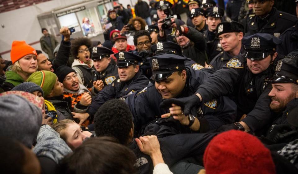 Police clash with demonstrators protesting the Staten Island, New York grand jury’s decision not to indict a police officer involved in the chokehold death of Eric Garner in December 2014 in New York City.