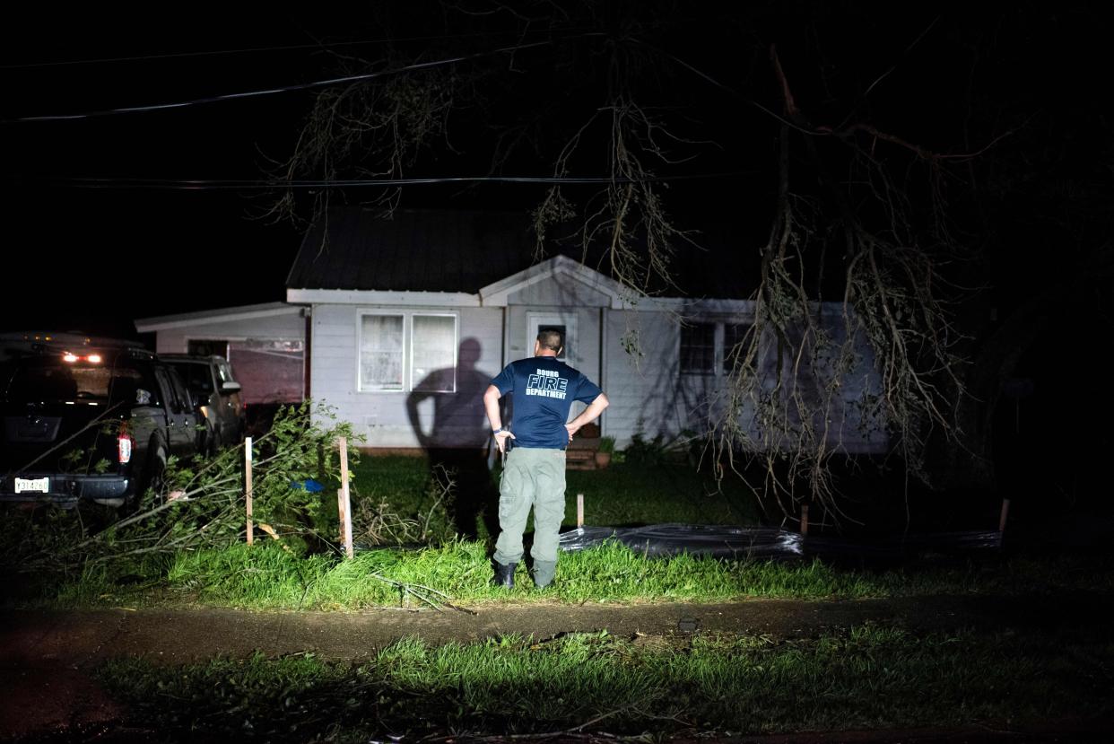 Bourg fire chief TJ Pellegrin asks a couple if they are okay after Hurricane Ida passed in Bourg, La. on Aug. 29, 2021. Hurricane Ida struck the coast of Louisiana on August 29 as a powerful Category 4 storm, 16 years to the day after deadly Hurricane Katrina devastated the southern city of New Orleans.