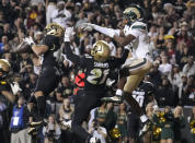 Colorado safety Trevor Woods, left, intercepts a pass as safety Shilo Sanders, center, covers Colorado State wide receiver Tory Horton in the second overtime of an NCAA college football game Saturday, Sept. 16, 2023, in Boulder, Colo. (AP Photo/David Zalubowski)