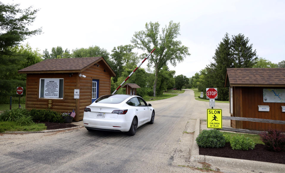 A car enters the gated community of Lost Lake near Dixon, Ill., Wednesday, June 12, 2024. Authorities said three sheriff's deputies were shot while responding to a report that someone inside a home in the Lost Lake community was threatening to kill themself or others. The suspect was also wounded. (AP Photo/Teresa Crawford)