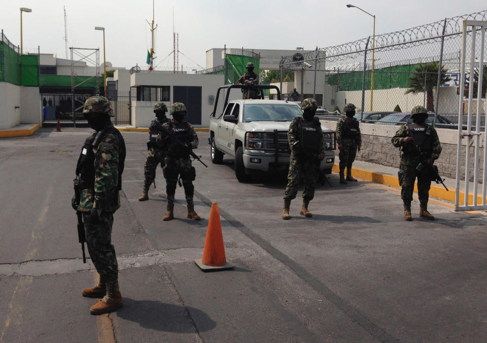 Mexican Navy Marines guard the entrance to a navy hangar where Mexican drug lord Joaquin "El Chapo" Guzman is expected to arrive in Mexico City, Saturday, Feb. 22, 2014. A senior U.S. law enforcement official said Saturday, that Guzman, the head of Mexico’s Sinaloa Cartel, was captured alive overnight in the beach resort town of Mazatlan. Guzman faces multiple federal drug trafficking indictments in the U.S. and is on the Drug Enforcement Administration’s most-wanted list. (AP Photo/Dario Lopez-Mills)