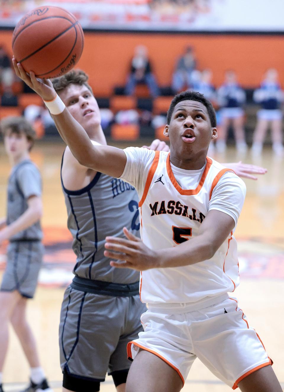 Massillon's Jalen Slaughter goes to the hoop with pressure from Hudson's Tino Yil-Junnila during Wednesday's game.