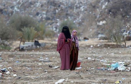 Palestinian women stand outside their dwellings in Khan Younis in the southern Gaza Strip. REUTERS/Ibraheem Abu Mustafa