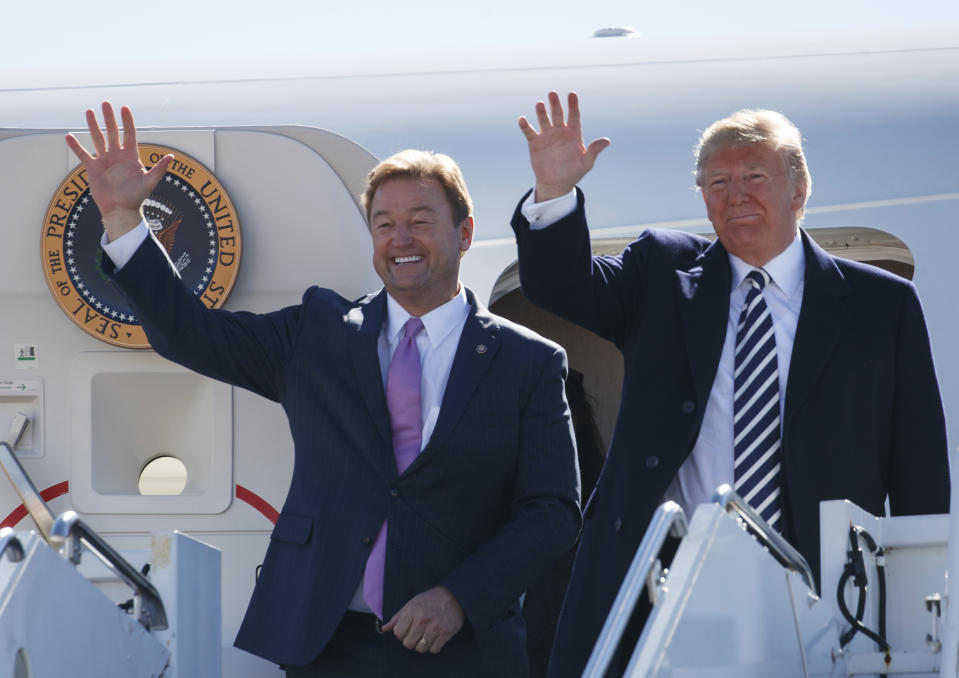 FILE - In this Oct. 20, 2018, file photo President Donald Trump, right, arrives with Sen. Dean Heller, R-Nev., on Air Force One at Elko Regional Airport in Elko, Nev., for a campaign rally. Heller was a Trump critic and later embraced him as he sought re-election to the U.S. Senate in 2018. Heller said Trump had been bullish the day before the election. Trump brushed off the loss, saying his base "wouldn't go for him" and recalling that Heller had been "extremely hostile" to him during the 2016 presidential election. (AP Photo/Carolyn Kaster, File)