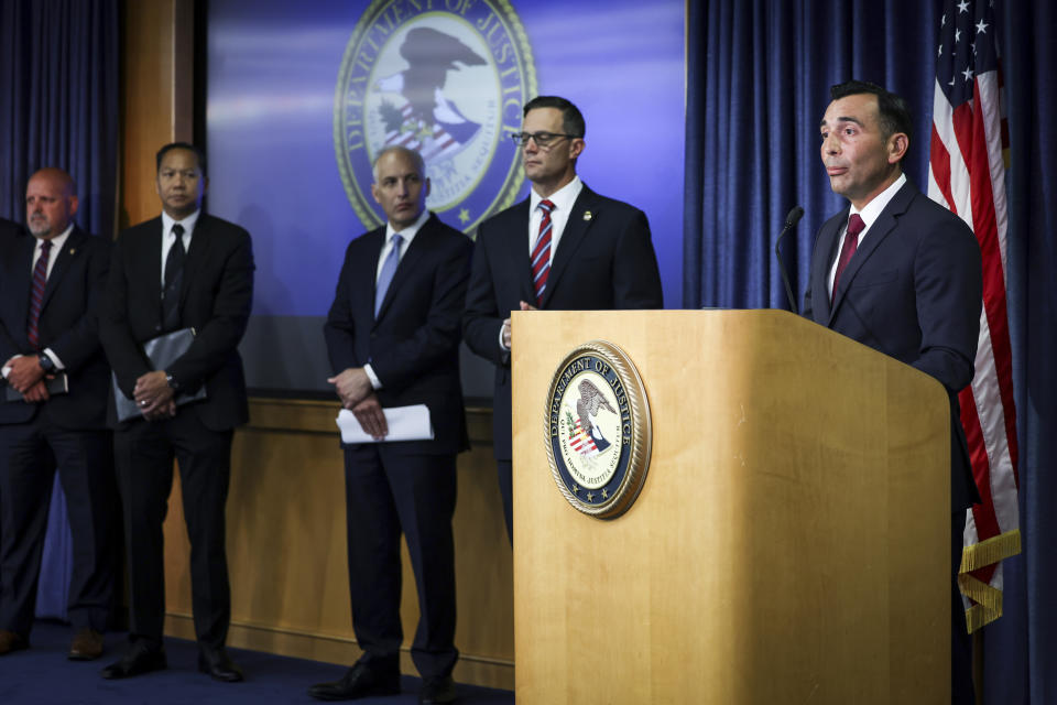 U.S. Attorney Martin Estrada for the Central District of California, right, speaks during a press conference at the U.S. Attorney's Office for the Southern District of California on Thursday, Aug. 3, 2023, in San Diego. Two U.S. Navy sailors have been arrested and accused of providing sensitive military information to China — including details on wartime exercises, Naval operations and critical technical material, federal officials said Thursday. (Meg McLaughlin/The San Diego Union-Tribune via AP)
