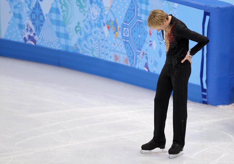 Evgeni Plushenko of Russia leaves the ice after pulling out of the men's short program figure skating competition due to illness at the Iceberg Skating Palace during the 2014 Winter Olympics, Thursday, Feb. 13, 2014, in Sochi, Russia. (AP Photo/Vadim Ghirda)