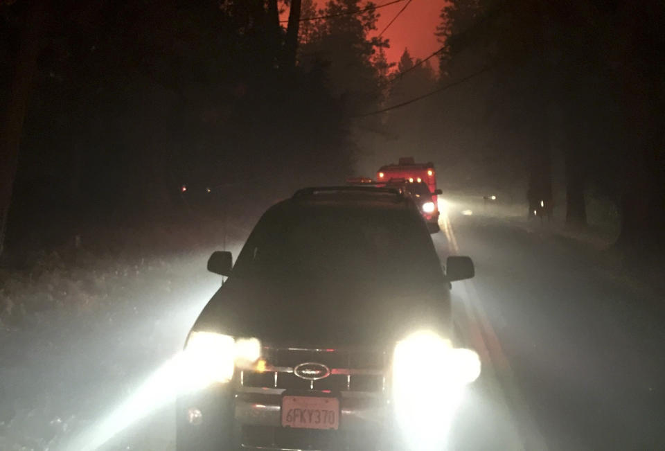 In this Nov. 8, 2018, photo shows vehicles crowded onto a street in Paradise, Calif., fleeing the Camp Fire. The scale of disaster in the Camp Fire was unprecedented, but the scene of people fleeing wildfire was familiar, repeated numerous times over the past three years up and down California from Redding and Paradise to Santa Rosa, Ventura and Malibu. In many of those communities, motorists became stuck in traffic as officials tried to evacuate thousands onto a few roads leading away from the flames. (Darrel Wilken via AP)