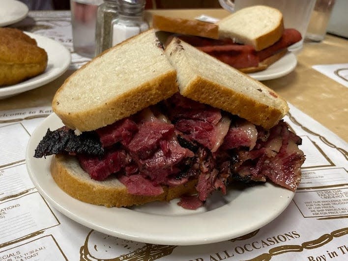 Pastrami sandwich on a plate.