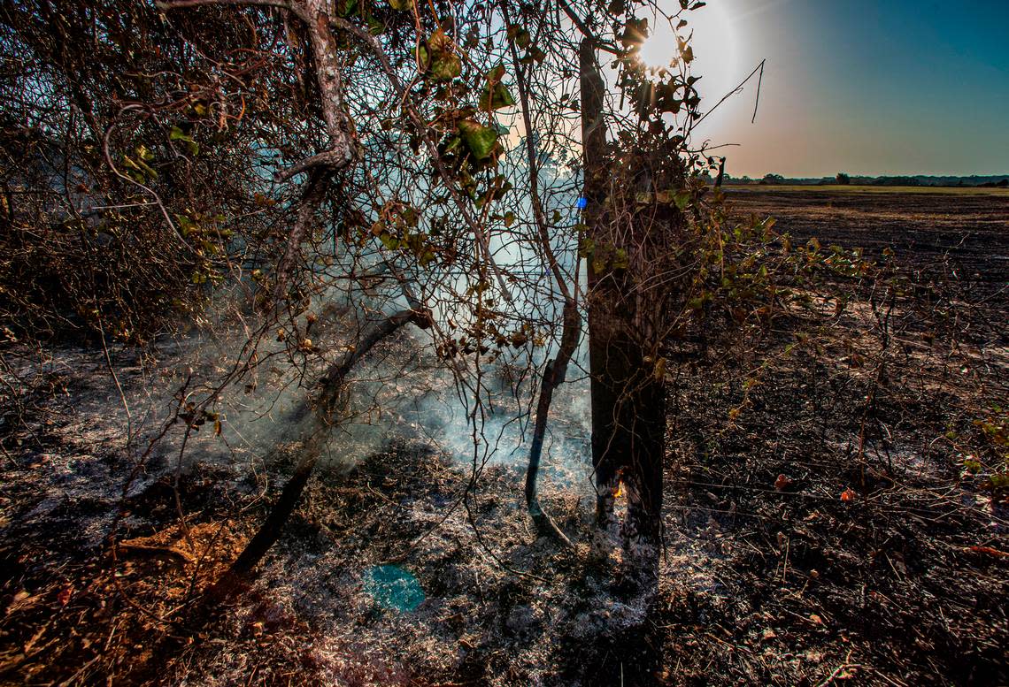 A fence post on a ranch along County Road 1005 in Somervell County is left smoldering on Wednesday, July 20, 2022. The Chalk Mountain fire ravaged ranches and scrubland near Glen Rose, damaging homes and vehicles left behind. The wildfire consumed more than 6,000 acres, forcing evacuations.