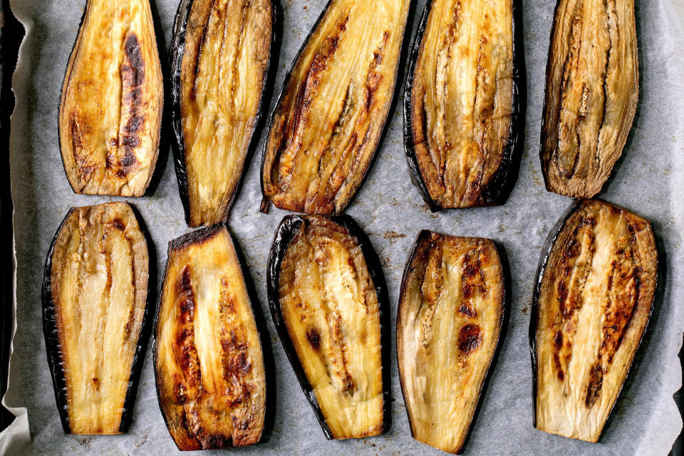 Sliced, grilled eggplant on baking paper