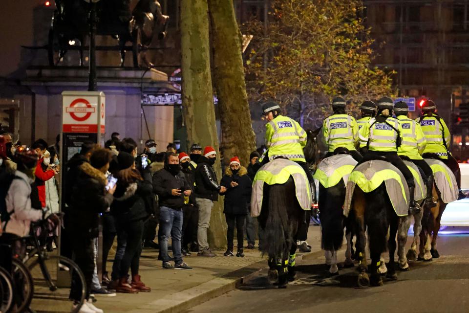 Mounted police officers patrol The Victoria Embankment as groups of revellers gather in a near-deserted London late on New Year's Eve, December 31, 2020, as authorities in the Tier 4 city hope the message to stay at home is obeyed. (Photo by Tolga Akmen / AFP) (Photo by TOLGA AKMEN/AFP via Getty Images)