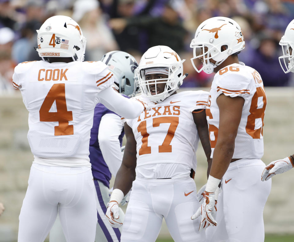 Texas kick returner D'Shawn Jamison (17) celebrates with Anthony Cook (4) and Jordan Pouncey (86) after returning a Kansas State punt for a touchdown during the first quarter of a college football game in Manhattan, Kan., Saturday, Sept. 29, 2018. (AP Photo/Colin E. Braley)