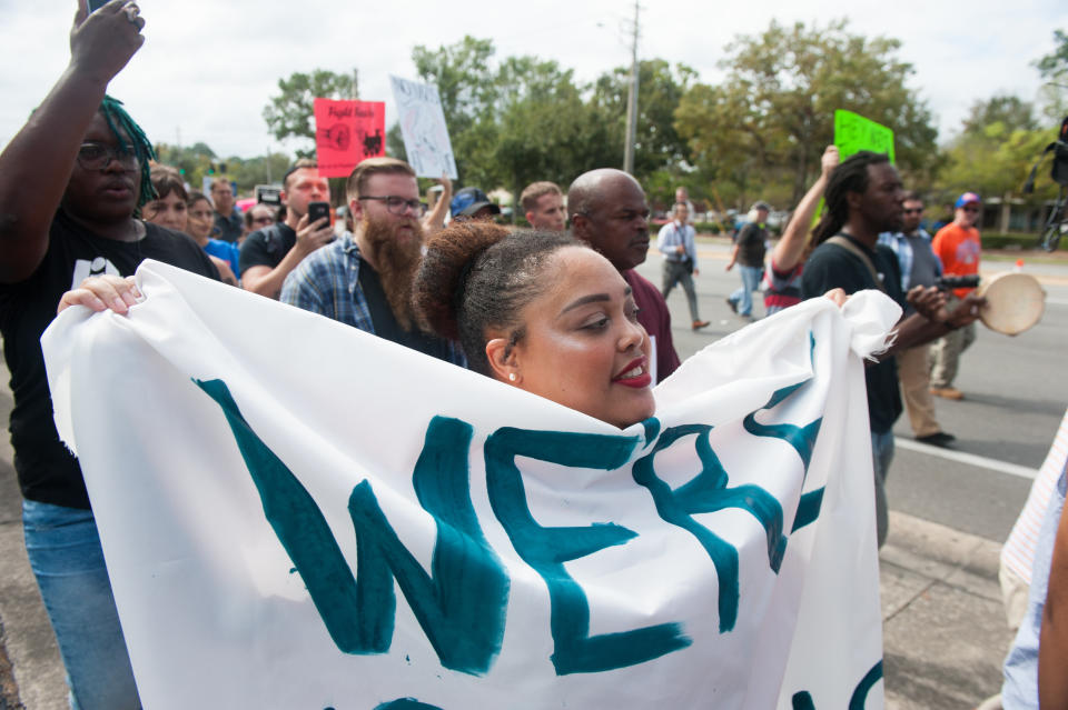 People march down 34th street to the entrance of the University of Florida.