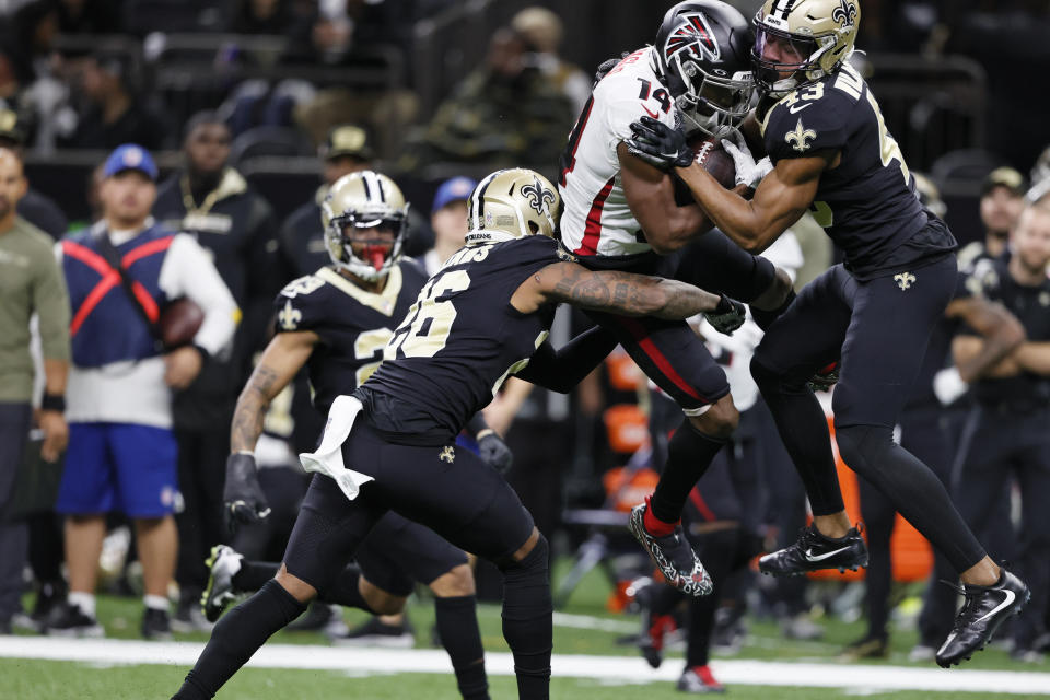 New Orleans Saints cornerback P.J. Williams (26) and New Orleans Saints free safety Marcus Williams (43) stop Atlanta Falcons wide receiver Russell Gage (14) during the first half of an NFL football game, Sunday, Nov. 7, 2021, in New Orleans. (AP Photo/Butch Dill)