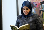 Samia Omar, Harvard University's first Muslim woman chaplain, reads through "The Chain of Prophets" at the school's office for Muslim chaplains in Cambridge, Mass., Nov. 30, 2021. Omar organizes a weekly discussion group for Muslim women on campus. (Aysha Khan/Religion News Service via AP)